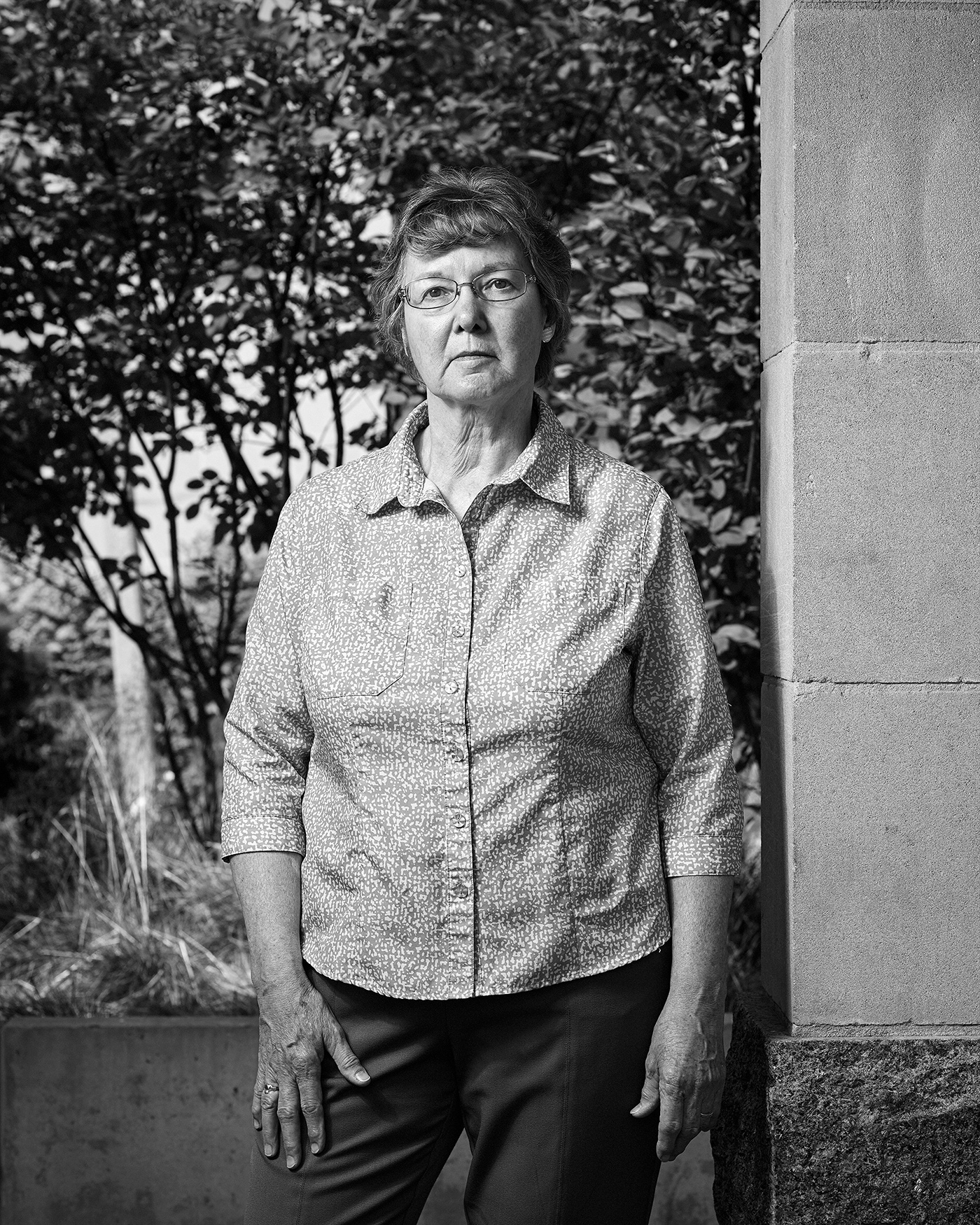 Portrait of Rosemary Keenan standing in the Peace Garden at Nathan Phillips Square in Toronto.