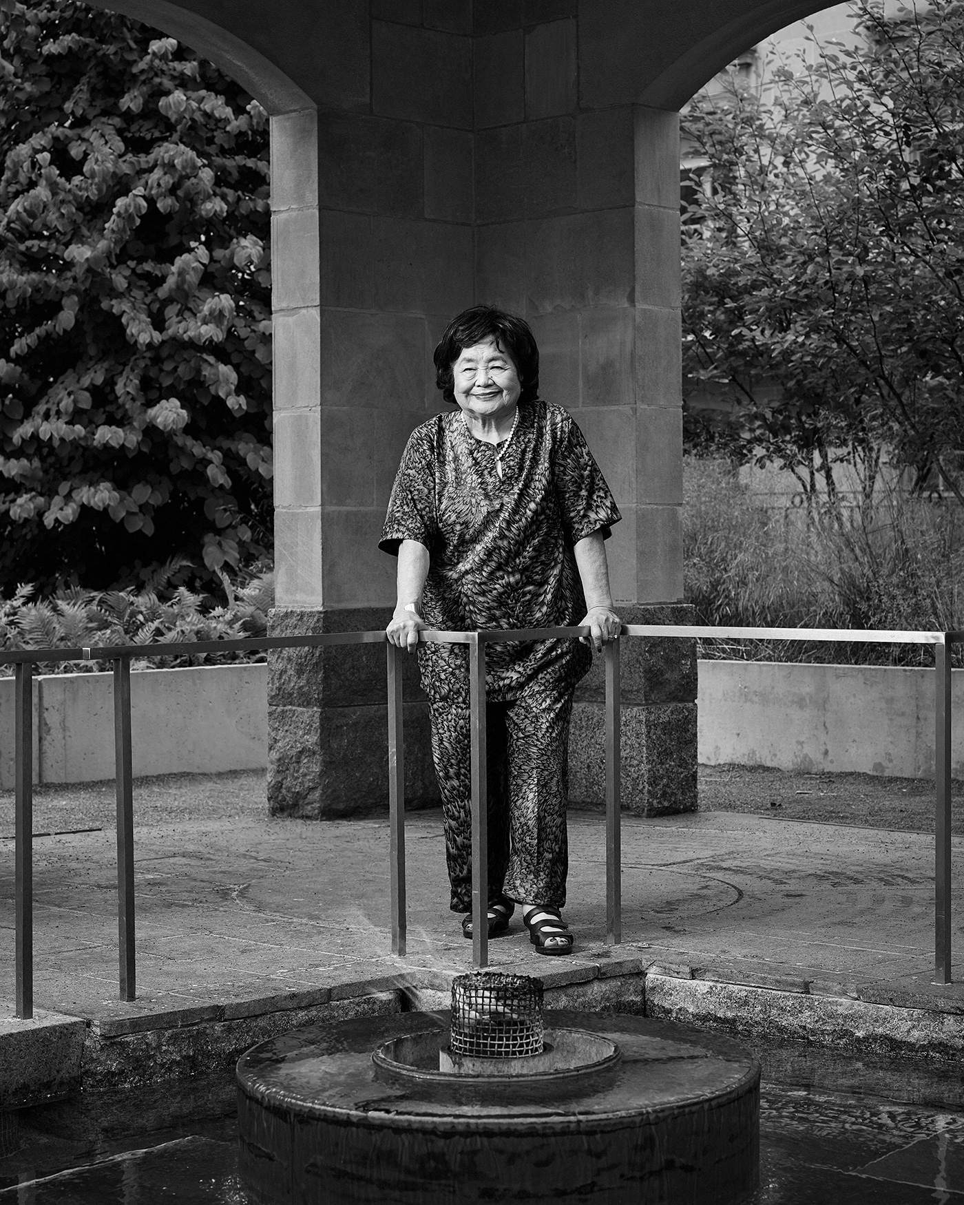 Portrait of Setsuko Thurlow standing by the Eternal Flame in the Peace Garden at Nathan Phillips Square in Toronto.