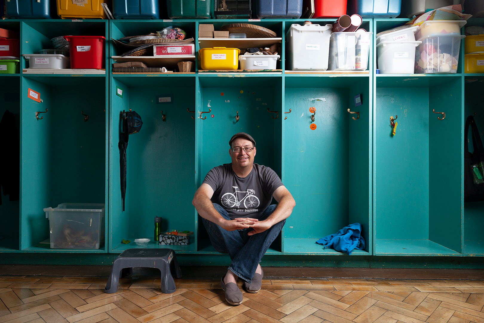 Stefan Lynch Strassfeld sits in a cubby in a classroom at Alpha Alternative School