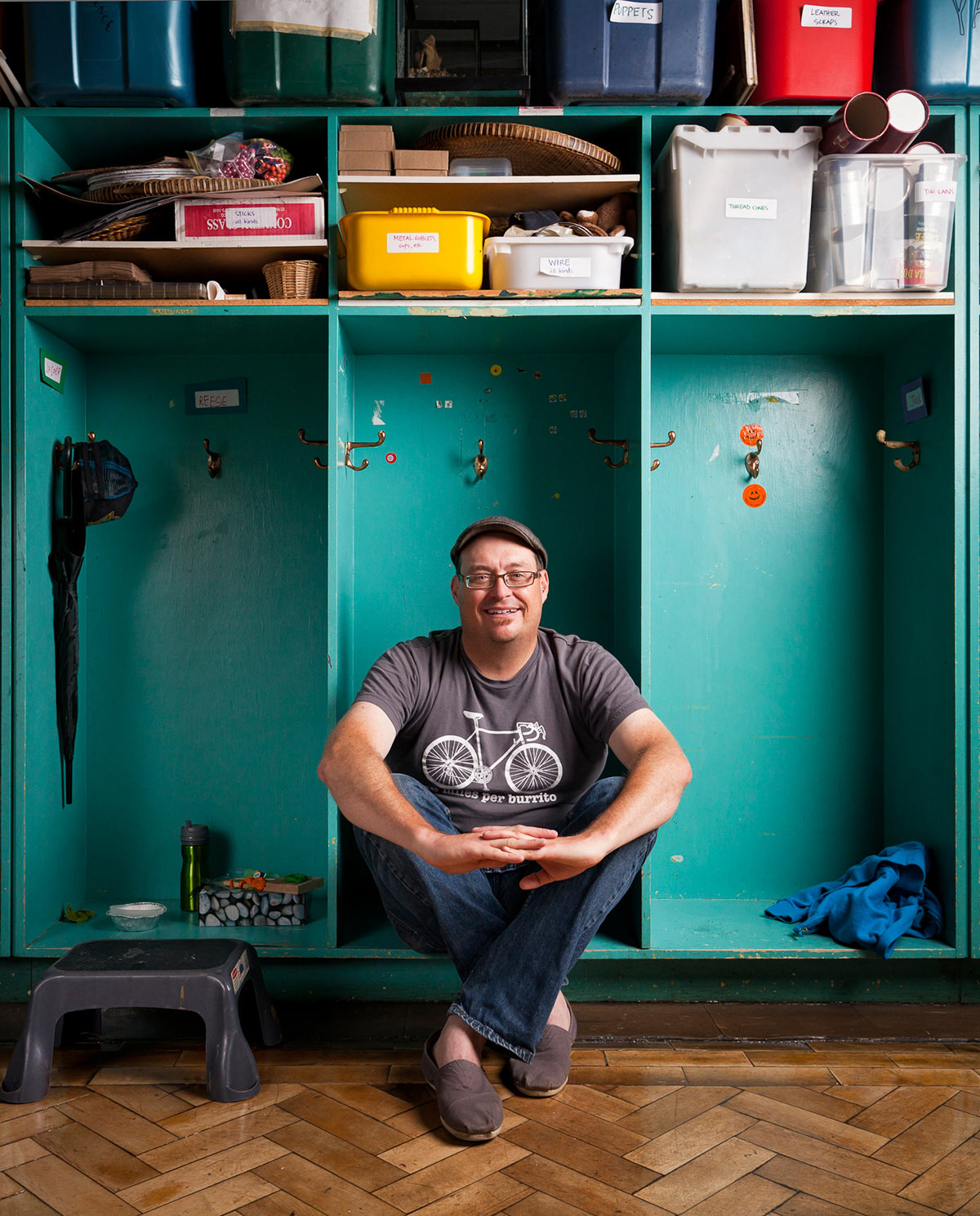 Stefan Lynch Strassfeld sits in a cubby in a classroom at Alpha Alternative School